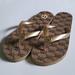 Michael Kors Shoes | Michael Kors Women's Flip Flops Embossed Mk Logo Size 6 9 9 10 11 Golden | Color: Brown/Gold | Size: Various