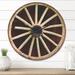 East Urban Home Country Wagon Wheel Wall Clock Solid Wood in Black/Brown/Yellow | 23 H x 23 W x 1 D in | Wayfair 36C829ED70B249C4AB8CE34A2E992B4E