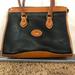 Dooney & Bourke Bags | Dooney & Bourke Black And Tan Handbag. Pre-Owned. In Vintage Used Condition. | Color: Black/Tan | Size: Os