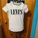 Levi's Tops | Levi's White Tshirt Top With Black Logo Few Stains Size Xs | Color: Black/White | Size: Xs