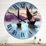Designart 'Sailing Boats In The Sea In Evening With City' Nautical & Coastal wall clock