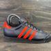 Adidas Shoes | Adidas Black & Neon Orange Low Top Big Kids Shoes Size 4.5 Us Sneakers | Color: Black | Size: 4.5bb