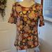 Lularoe Tops | Lularoe Gigi Short Sleeve Tee Shirt Orange Gold Blue Green Floral Print M New | Color: Gold/Purple | Size: M