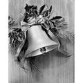 Close-up of a Christmas bell with holly leaves hanging on a wall Poster Print (24 x 36)