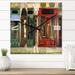 Designart 'Red Facade of Charming Shop In Paris II' French Country wall clock