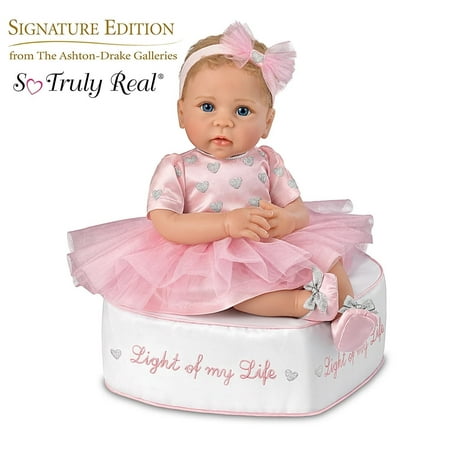 The Ashton - Drake Galleries Light of My Life So Truly RealÂ® Lifelike Baby Girl Doll with Light Up Skirt and Ottoman Set Weighted Poseable RealTouchÂ® Vinyl Skin by Doll Artist Linda Murray 18 -inches