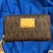 Michael Kors Accessories | Michael Kors Wristlet -Used Several Times, From A Smoke & Pet Free Home. | Color: Brown/Tan | Size: Small