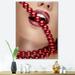 DESIGN ART Designart Woman Mouth With Red Lipstick Biting Red Pearls Modern Canvas Wall Art Print 24 in. wide x 32 in. high