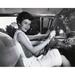 Young Woman Sitting in the Drivers Seat of a Car & Smiling Poster Print - 18 x 24 in.
