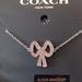 Coach Jewelry | Coach Pink Bow Adjustable Slider Bracelet | Color: Pink/Silver | Size: Os