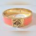 Kate Spade Jewelry | Kate Spade Gold Tone Peach Enamel Turn Lock Hinged Bracelet | Color: Gold/Orange | Size: Os