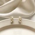 Boucles d'oreilles pendantes en perles blanches pour femmes boucles d'oreilles rondes dorées