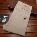 Jeans da uomo estivi slim fit piedi piccoli pantaloni da lavoro di tendenza alla moda kaki elastici semplici e versatili