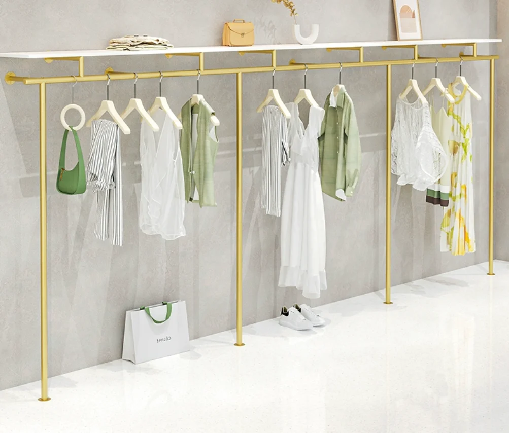 Clothing store hangers, iron art on the wall, golden shelves, display racks, women's clothing store clothing display racks