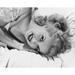 Portrait of a young woman lying on the bed Poster Print (24 x 36)