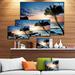Design Art 'Lonely Palm Tree on Rocky Beach' Photographic Print on Wrapped Canvas in Blue/Orange | 8 H x 12 W x 1 D in | Wayfair PT10873-12-8