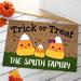 The Holiday Aisle® Aguon Candy Corn Family of Three Personalized 18 in. x 27 in. Non-Slip Outdoor Door Mat Synthetics | Wayfair