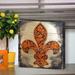 Fleur De Lis Living Cross Fleur-De-Lis on Wooden Block Wall Décor in Brown/Green/Orange | 12 H x 12 W x 1.5 D in | Wayfair